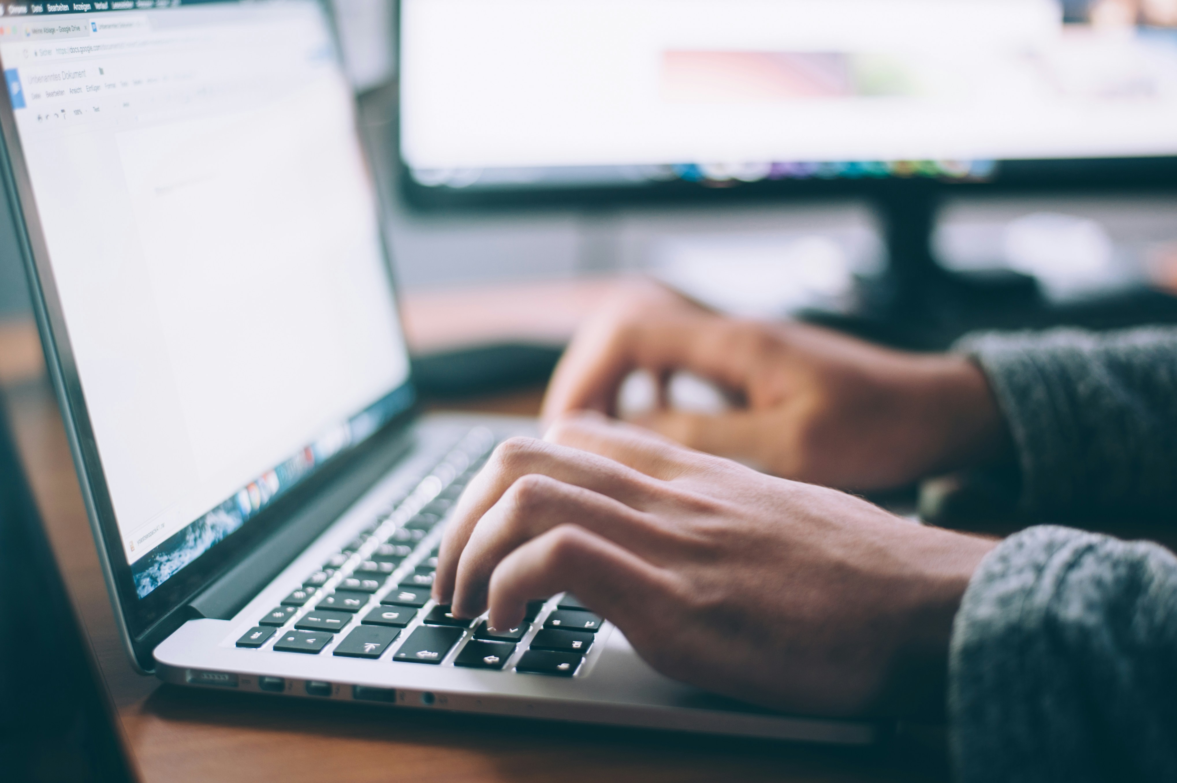 Research process with hands typing on a laptop